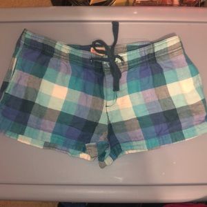 Turquoise, Blue, and white plaid drawstring cargo shorts.